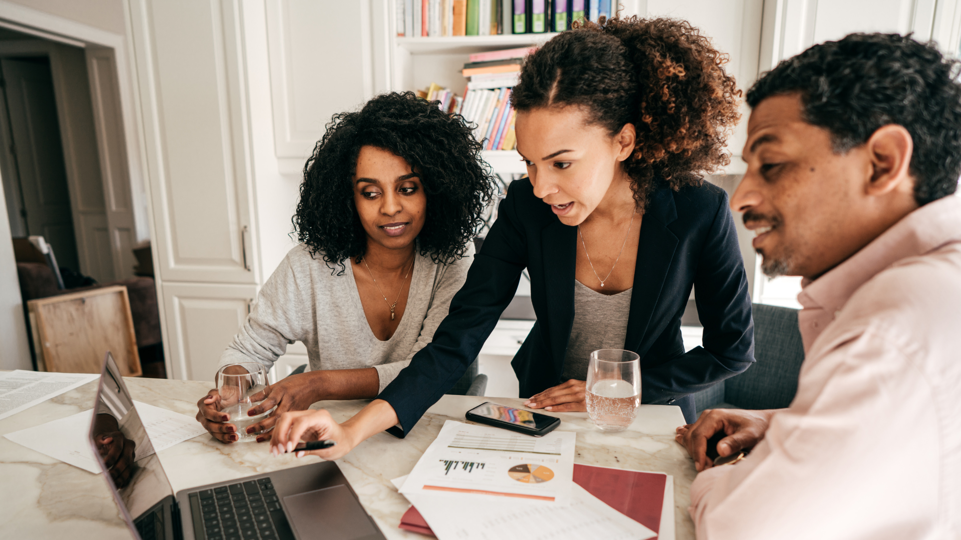 A financial team doing a quarterly analysis of their business on the computer.