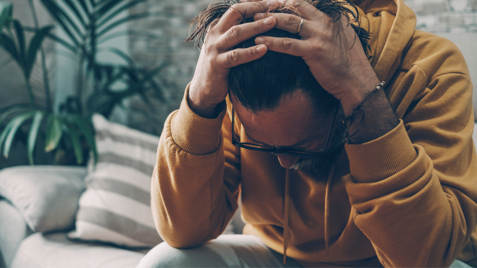 A person holding their hands over their head showing frustration