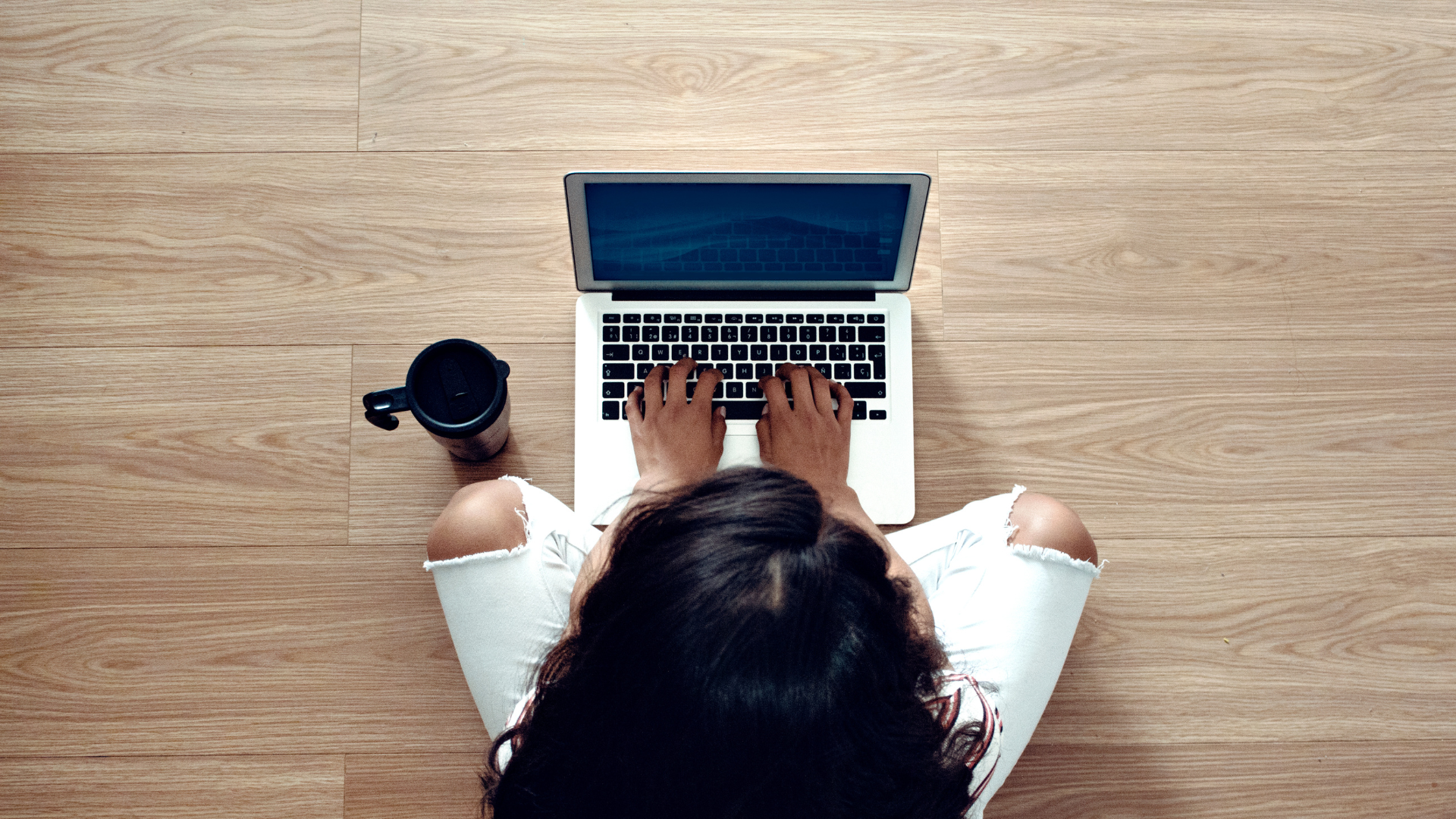 A woman typing on a computer.